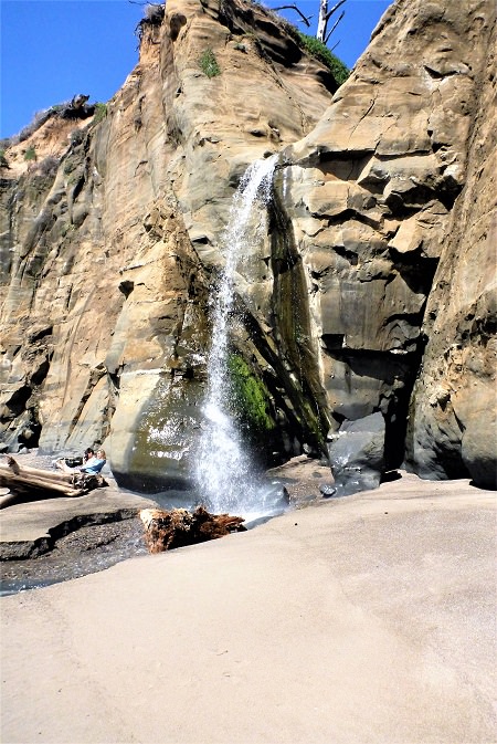 waterfall between rock at the beach