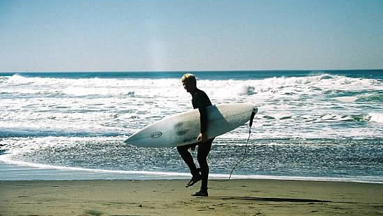 surfer getting ready to enter the water